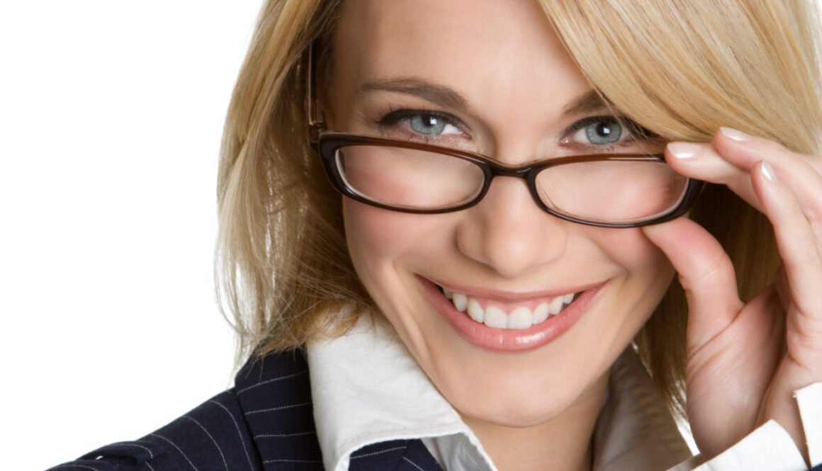 A young attractive woman with glasses looking directly at the viewer to convey the importance of optimizing your linkedin about section