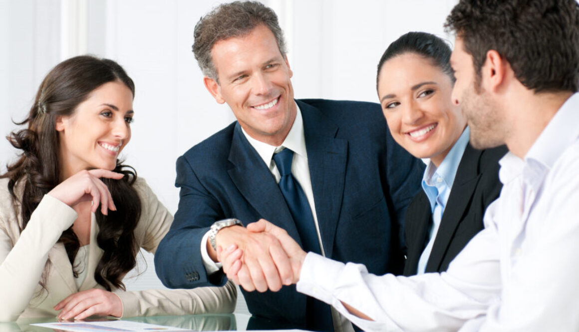 Group of professionals shaking hands.