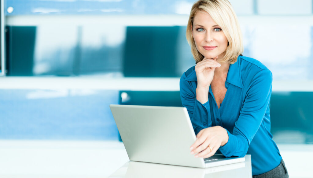 Attractive young woman uses a computer to develop effective prospecting messages