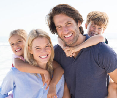 Young happy couple with two kids happy they qualify for $5M life insurance without exam or labs