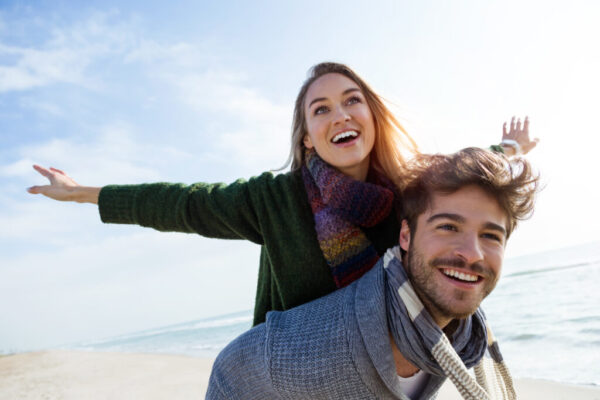 Happy young couple enjoying the day in a cold winter on the beach. Happy Couple exploring Life Insurance Underwriting Strategies for Diabetics