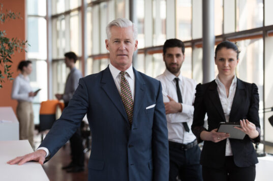 Group of business professionals looking straight at the camera.