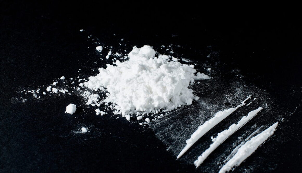 Cocaine divided into paths on a black background Cocaine