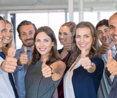 Group of young professionals giving the thumbs up