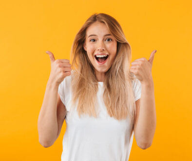 Young woman gives two thumbs up