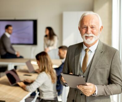 Successful male business owner with iPad looking at the camera.