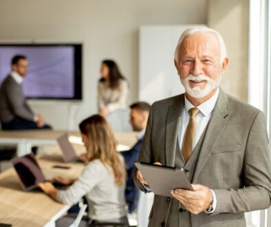 Successful male business owner with iPad looking at the camera.