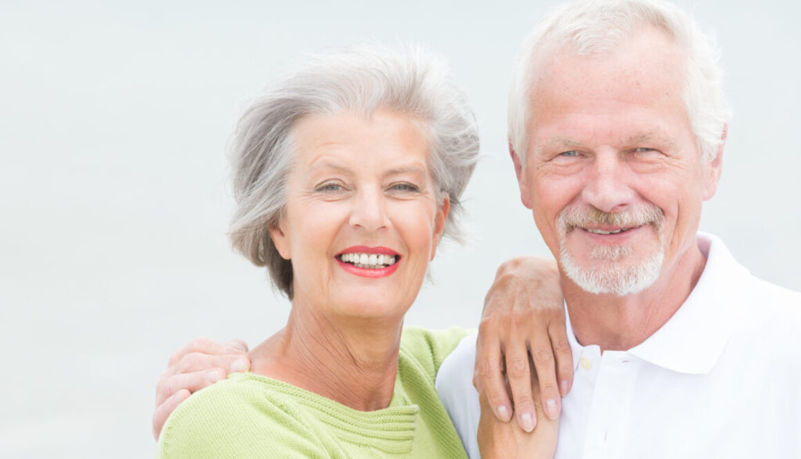 Older couple looking at camera with a big smile