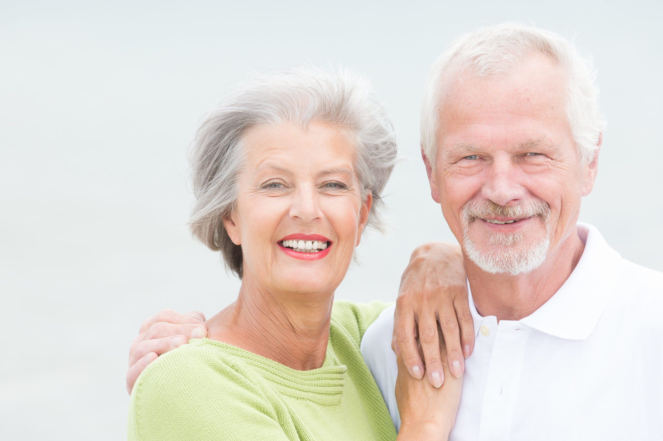 Older couple looking at camera with a big smile