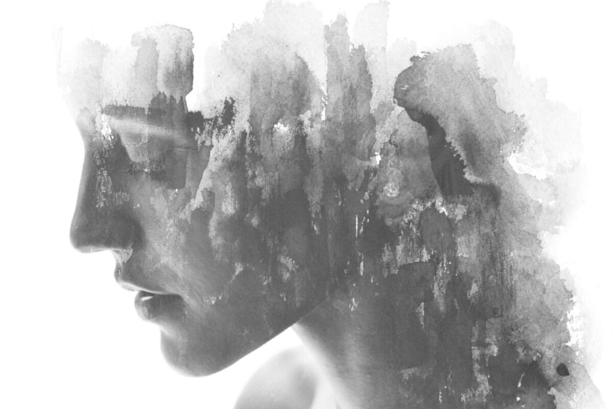 Paintography. Double exposure. Close up of an attractive model combined with hand drawn ink and watercolor painting with overlapping brushstroke texture, black and white Artistic rendering of a woman that suggests she is suffering from depression