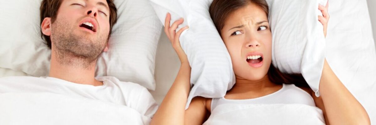 Snoring man - couple in bed Couple in bed with the man having sleep apnea